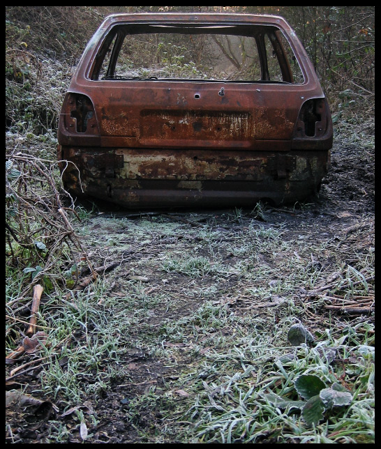 Photo of abandoned car in forest